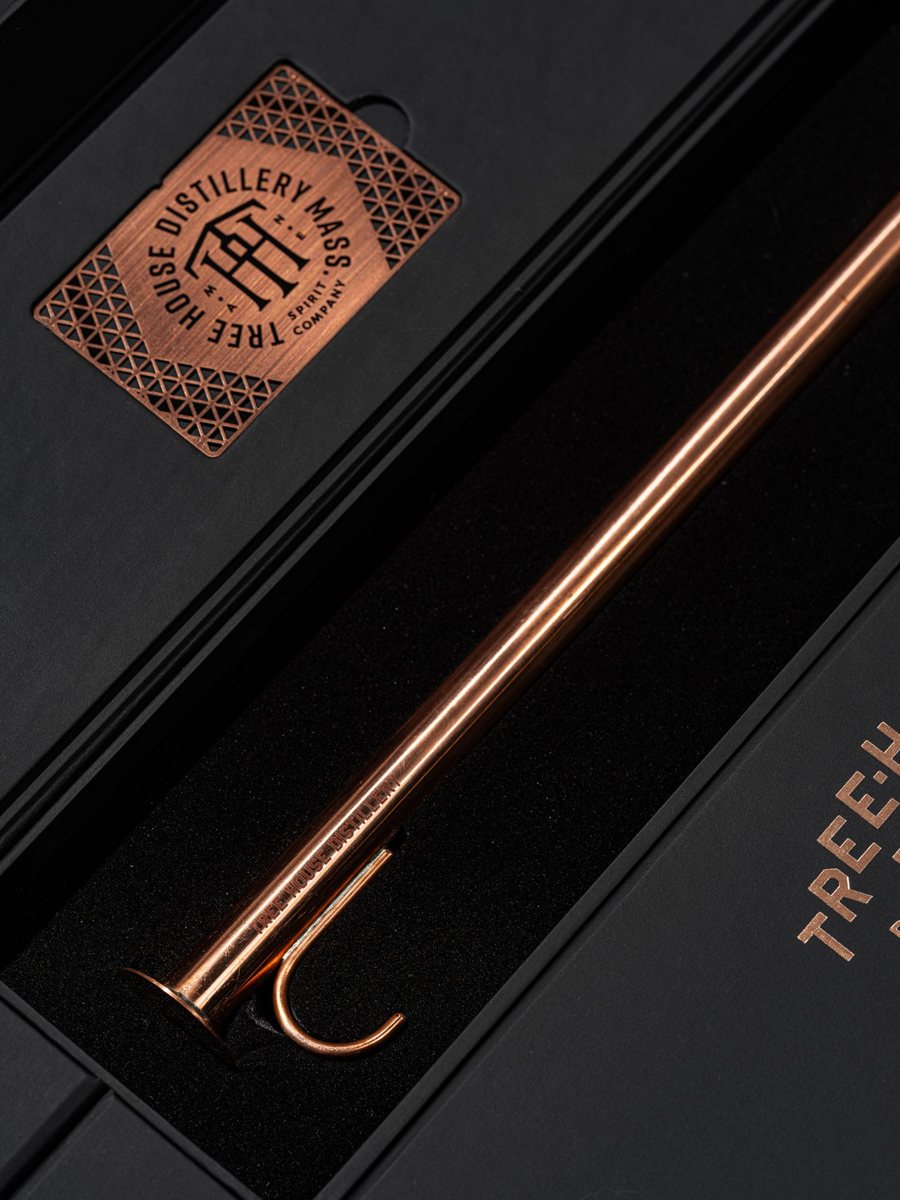 A copper whiskey thief and a copper Tree House Distillery member card in a black presentation box